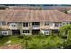 Aerial view of townhouse building, showcasing balconies and backyard at 8712 The Esplanade # 19, Orlando, FL 32836