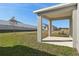 Covered patio overlooking a grassy backyard with a privacy fence at 27512 Stellar Sea Way, Howey In The Hills, FL 34737
