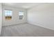 Bright bedroom with two windows and grey carpet at 27512 Stellar Sea Way, Howey In The Hills, FL 34737