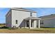 Two-story house exterior with covered patio and AC unit at 27512 Stellar Sea Way, Howey In The Hills, FL 34737