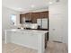 Modern kitchen with stainless steel appliances and an island at 27512 Stellar Sea Way, Howey In The Hills, FL 34737