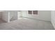 Spacious loft area with grey carpeting and window at 27512 Stellar Sea Way, Howey In The Hills, FL 34737