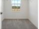 Spacious walk-in closet with grey carpet and a window at 27512 Stellar Sea Way, Howey In The Hills, FL 34737