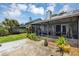Relaxing screened porch with patio furniture and lush landscaping at 551 Cidermill Pl, Lake Mary, FL 32746