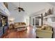 Bright living room with hardwood floors, vaulted ceilings, and sliding glass doors to a patio at 551 Cidermill Pl, Lake Mary, FL 32746