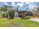 Back exterior view showcasing a screened porch and solar panels at 551 Cidermill Pl, Lake Mary, FL 32746