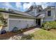 Gray two-story house with a black door and landscaping at 551 Cidermill Pl, Lake Mary, FL 32746