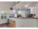 Kitchen features white cabinets, stainless steel appliances, and a breakfast bar at 551 Cidermill Pl, Lake Mary, FL 32746