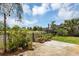 Spacious backyard patio with string lights, planters, and a pond view at 551 Cidermill Pl, Lake Mary, FL 32746