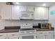 Well-equipped kitchen with white cabinets, updated appliances, and ample counter space at 551 Cidermill Pl, Lake Mary, FL 32746