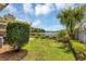 Landscaped backyard with pond view and lush greenery at 551 Cidermill Pl, Lake Mary, FL 32746