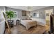 Cozy bedroom with wood-look floors and a full wall mirror at 551 Cidermill Pl, Lake Mary, FL 32746