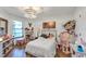 Bright bedroom featuring a double bed, built-in shelves, and hardwood floors at 551 Cidermill Pl, Lake Mary, FL 32746