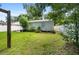 Spacious backyard with a large grassy area and white vinyl fence at 108 S Glenwood Ave, Orlando, FL 32803