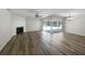 Living room with fireplace, pool view, and wood-look flooring at 3235 Cross Fox Dr, Mulberry, FL 33860