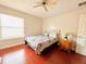 Bedroom with wood floors and a bed with gray bedding at 9060 Heritage Bay Cir, Orlando, FL 32836