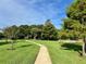 Paved path winding through a lush, green community park at 9060 Heritage Bay Cir, Orlando, FL 32836