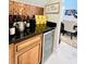 Wet bar with wine cooler, wine storage and a black countertop at 9060 Heritage Bay Cir, Orlando, FL 32836