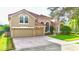 Two-story house with a double-car garage and manicured lawn at 9060 Heritage Bay Cir, Orlando, FL 32836