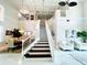 Grand staircase with dark wood treads and white railings at 9060 Heritage Bay Cir, Orlando, FL 32836