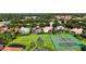 Aerial view of house, tennis courts, and lush landscape at 9060 Heritage Bay Cir, Orlando, FL 32836