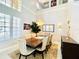 Dining room with a large wooden table, high ceilings, and a chandelier at 9060 Heritage Bay Cir, Orlando, FL 32836