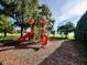 playground with lake access in a community at 9060 Heritage Bay Cir, Orlando, FL 32836