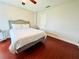 Bedroom with wood floors and a bed with white bedding at 9060 Heritage Bay Cir, Orlando, FL 32836
