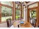 Bright breakfast nook with wood table, chairs, and views of the garden at 1750 Taylor Woods Rd, Deland, FL 32724