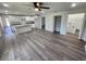 Open-concept living area with hardwood floors and modern kitchen at 2220 Church St, Sanford, FL 32771