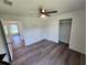 Bedroom with grey vinyl flooring, ceiling fan, and a door to another room at 2220 Church St, Sanford, FL 32771