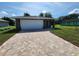 Newly constructed home with a paved driveway and a single car garage at 2220 Church St, Sanford, FL 32771