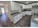 Modern kitchen features white shaker cabinets, granite countertops, and vinyl plank flooring at 2220 Church St, Sanford, FL 32771