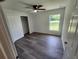 Bedroom featuring grey vinyl flooring, a window, and closet with sliding doors at 2220 Church St, Sanford, FL 32771