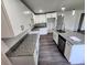 Modern kitchen with white cabinets, granite countertops and stainless steel appliances at 2220 Church St, Sanford, FL 32771