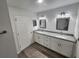 Double vanity bathroom with granite countertops and a large mirror at 2220 Church St, Sanford, FL 32771