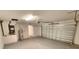 Spacious garage featuring an overhead door and extra storage space at 2220 Church St, Sanford, FL 32771