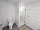 Bathroom features a toilet and a large walk-in shower at 2220 Church St, Sanford, FL 32771