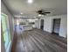 Open living space with vinyl plank flooring and a modern kitchen at 2220 Church St, Sanford, FL 32771