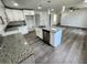 Modern kitchen with white cabinets, granite counters, and kitchen island at 2243 Greenway St, Sanford, FL 32771