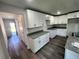 Modern kitchen with white cabinets, granite countertops and island at 2243 Greenway St, Sanford, FL 32771