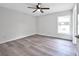 Well-lit bedroom featuring vinyl flooring and a ceiling fan at 2261 Greenway St, Sanford, FL 32771
