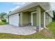 Green house exterior with white garage door and paver driveway at 2261 Greenway St, Sanford, FL 32771