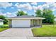 Front view of a newly built green house with a white garage door at 2261 Greenway St, Sanford, FL 32771