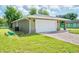 House exterior showcasing the garage and side yard at 2261 Greenway St, Sanford, FL 32771