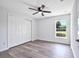 Bright bedroom with vinyl plank flooring, large closet, and a window with a view at 2261 Greenway St, Sanford, FL 32771