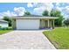 New construction home with white garage door and paver driveway at 2261 Greenway St, Sanford, FL 32771