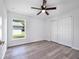 Spacious bedroom with vinyl flooring, window, and sliding door closet at 2261 Greenway St, Sanford, FL 32771