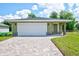 New construction home with a green exterior, white garage door, and paved driveway at 2261 Greenway St, Sanford, FL 32771
