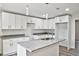 Modern kitchen with white shaker cabinets, granite countertops and island at 2261 Greenway St, Sanford, FL 32771